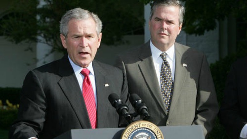 Former President George W. Bush standing with brother Jeb, former governor of Florida/Photo courtesy of the Chicago Tribune